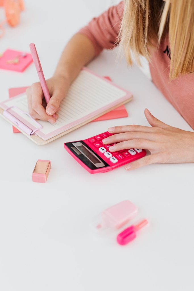 A student using a calculator while planning a budget.